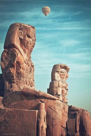 The Colossi of Memnon, two massive statues in Luxor, captured with Egypt Tour Magic.