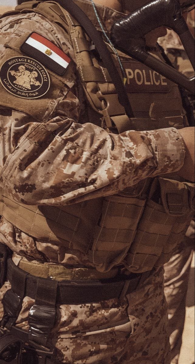 Close-up of an Egyptian police officer's tactical gear with flag and rescue unit insignia.