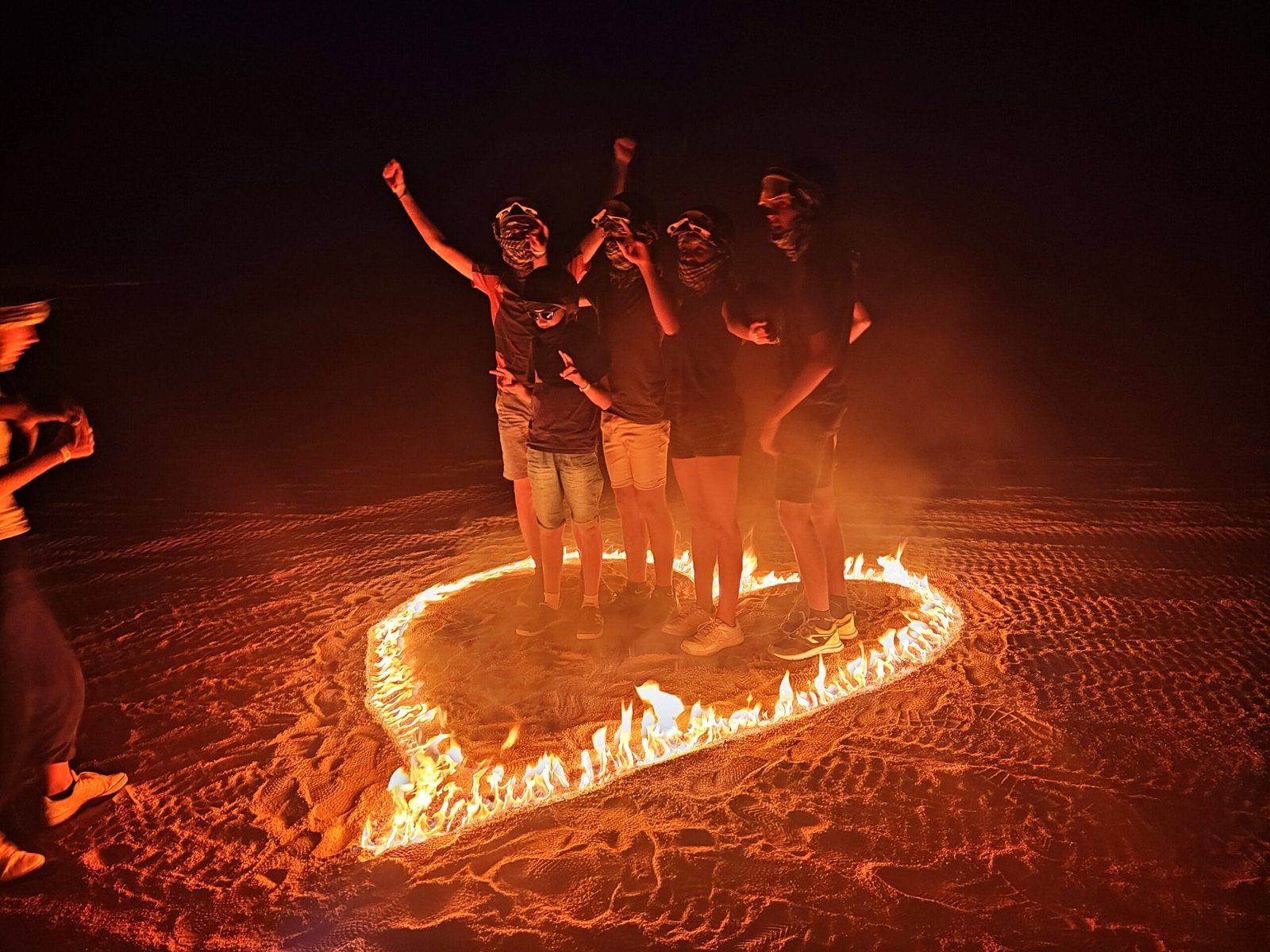 Visitors creating a heart of fire during a safari with Egypt Tour Magic.