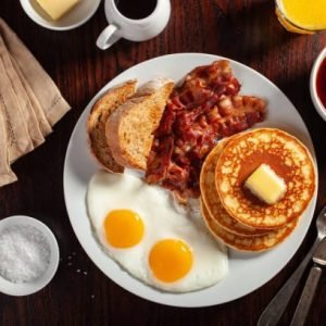 traditional full american breakfast eggs pancakes with bacon and toast